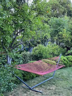 a hammock sitting in the grass in a garden at Redwood Garden in Sacramento