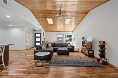 a living room with a couch and a ceiling at Peaceful Creekside Buddha Retreat in Groveland