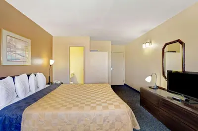 a hotel room with a bed and a flat screen tv at Howard Johnson by Wyndham South Lake Tahoe in Bijou