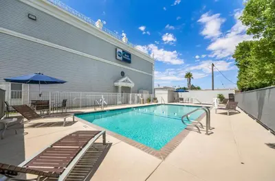 a swimming pool in front of a building at Best Western Executive Inn in Los Banos