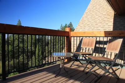 two chairs and a table on a deck at Courtwood Inn in Murphys
