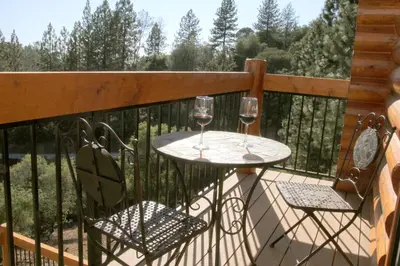two glasses of wine sitting on a deck at Courtwood Inn in Murphys