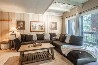 a living room with a couch and a table at Sierra Park Villas #76, Updated 1 Bedroom + 2 Lofts, 2 Bath, Sleeps 6! in Mammoth Lakes