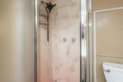 a shower with a glass door next to a toilet at Sierra Park Villas #76, Updated 1 Bedroom + 2 Lofts, 2 Bath, Sleeps 6! in Mammoth Lakes