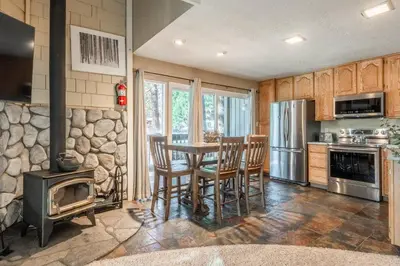 a kitchen with a table with chairs and a stove at Sierra Park Villas #76, Updated 1 Bedroom + 2 Lofts, 2 Bath, Sleeps 6! in Mammoth Lakes