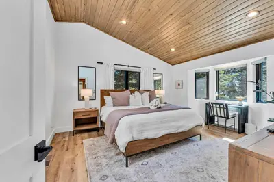 a bedroom with a bed and a wooden ceiling at Modern Mountain Luxury Retreat, Hot Tub & Grill in Carnelian Bay