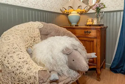 a stuffed animal sitting on a chair next to a table at Sunset Summit Villa 2 min from Bass Lake in Bass Lake