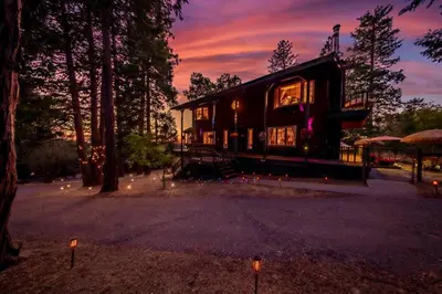 a house with lights in front of it at Sunset Summit Villa 2 min from Bass Lake in Bass Lake
