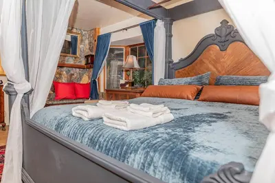 a bedroom with a bed with towels on it at Sunset Summit Villa 2 min from Bass Lake in Bass Lake