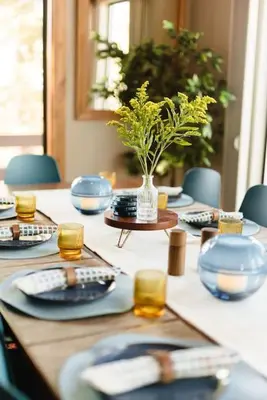 a table with blue plates and a vase on it at Alpenglow Aerie - StayLuxe Rubicon in Meeks Bay