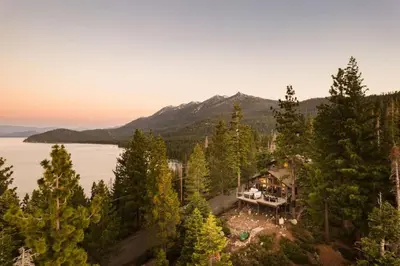 an aerial view of a house in the trees at Alpenglow Aerie - StayLuxe Rubicon in Meeks Bay