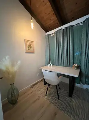a room with a desk and a vase of flowers at The Pad at South Lake Tahoe in Bijou Park