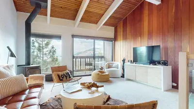 a living room with a couch and a tv at Mammoth Point #117 condo in Mammoth Lakes