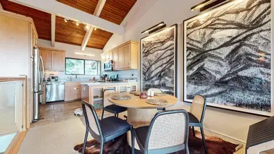 a kitchen with a table and chairs in a room at Mammoth Point #117 condo in Mammoth Lakes