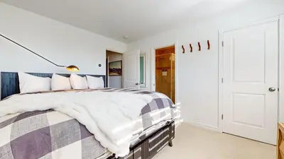 a bedroom with a large bed with a purple and white blanket at Mammoth Point #117 condo in Mammoth Lakes