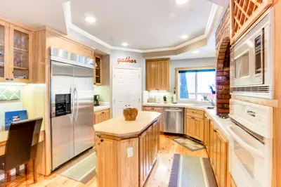 a kitchen with wooden cabinets and stainless steel appliances at The Gathering Place in Truckee