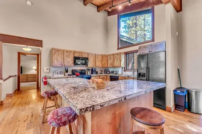 a kitchen with a large island with a counter top at Northstar Retreat by Golf Course & Free Shuttle in Truckee