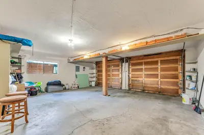 a garage with two wooden garage doors in a room at Northstar Retreat by Golf Course & Free Shuttle in Truckee