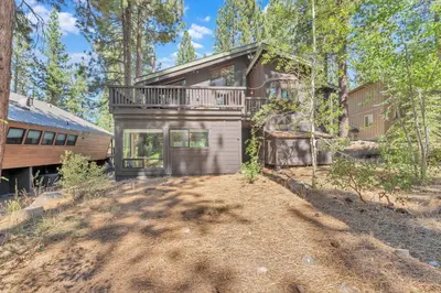 a house in the woods with a dirt road in front at Northstar Retreat by Golf Course & Free Shuttle in Truckee