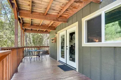 a covered porch with a table and chairs on it at Mtn-View Gem Deck, Grill and Fire Pit in West Point in Volcano
