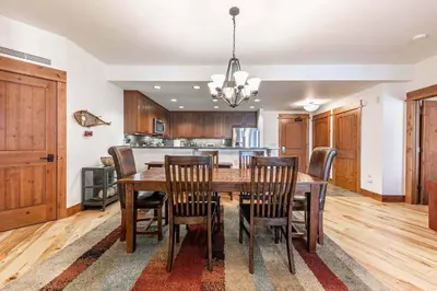 a dining room with a wooden table and chairs at Big Horn Lodge 307 by East West Hospitality in Truckee