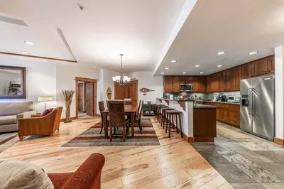 a kitchen and living room with a table and chairs at Big Horn Lodge 307 by East West Hospitality in Truckee