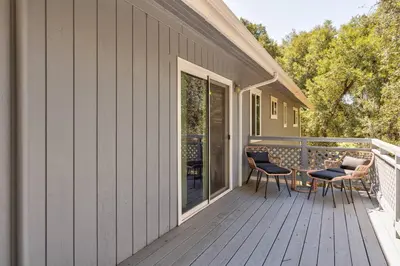 a deck with chairs and a table on a house at Bald Bear Barracks in Mariposa