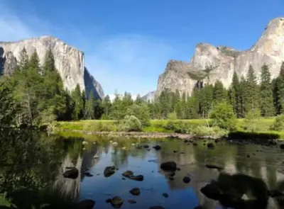 a river with trees and mountains in the background at Bald Bear Barracks in Mariposa