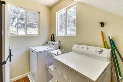 a laundry room with a washer and dryer and windows at Sonora Hilltop Home Scenic Views, Pet Friendly! in Sonora
