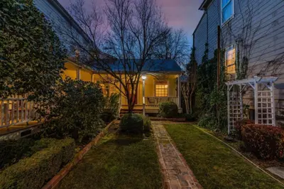 a house with a lawn in front of a building at Timeless Victorian Gem w Breathtaking Mountains in Sutter Creek