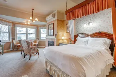 a bedroom with a large bed with an orange canopy at Romantic Victorian Getaway The Garden in Sutter Creek