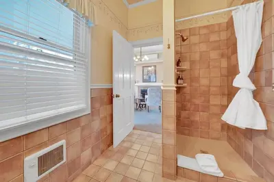 a bathroom with a shower and a window at Romantic Victorian Getaway The Garden in Sutter Creek