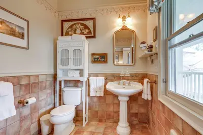 a bathroom with a toilet and a sink at Romantic Victorian Getaway The Garden in Sutter Creek