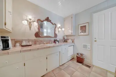 a bathroom with a sink and a mirror on the wall at Romantic Victorian Getaway The Hideaway in Sutter Creek