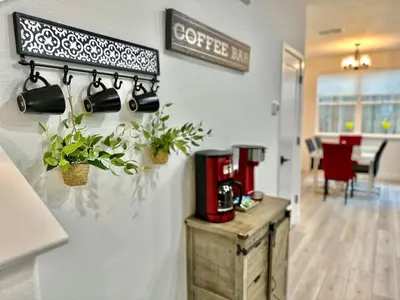a coffee bar with plants and a coffee maker on a wall at Charming and Modern 3-Bedroom Home in Rocklin in Rocklin