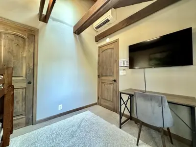 a room with a desk with a television and a chair at Cozy Tahoe Retreat Huge Yard in South Lake Tahoe