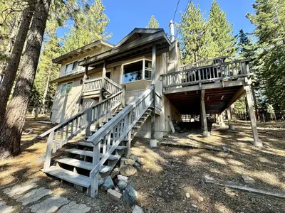 a tree house with stairs leading up to it at Cozy Tahoe Retreat Huge Yard in South Lake Tahoe