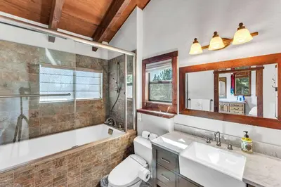 a bathroom with a tub and a toilet and a sink at Updated Tahoe Retreat Near Trails with Game Room in Kings Beach