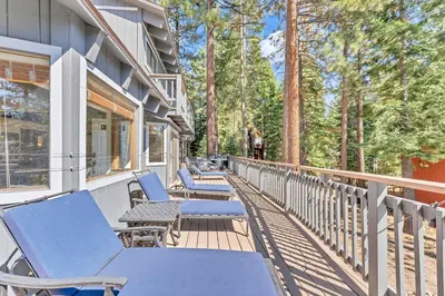 a row of chairs on a porch with trees at Updated Tahoe Retreat Near Trails with Game Room in Kings Beach