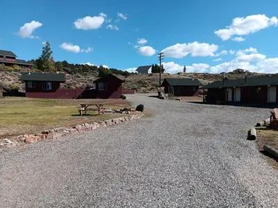 a gravel road with a picnic table and buildings at Big Meadow Lodge in Bridgeport
