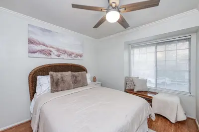 a bedroom with a bed and a ceiling fan at Chic Boho 3BR Home Near Woodward Park in Fresno