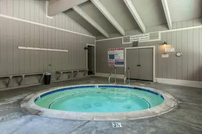 a swimming pool in a building with a large circle in the middle at Mammoth TwnHm hot tub walk to town in Mammoth Lakes