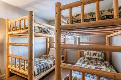 a couple of bunk beds in a room at Mammoth TwnHm hot tub walk to town in Mammoth Lakes