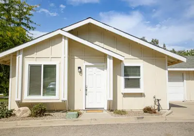 a white house with a white door at Beautiful Condo by Park Entrance in Three Rivers