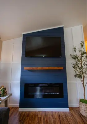 a blue wall with a tv above a fireplace at Beautiful Condo by Park Entrance in Three Rivers