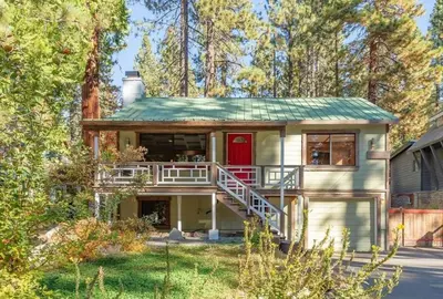 a house with a red door and a balcony at New Cabin in North Lake Tahoe! in Kings Beach