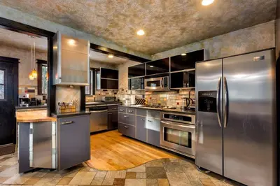 a large stainless steel kitchen with stainless steel appliances at New Cabin in North Lake Tahoe! in Kings Beach