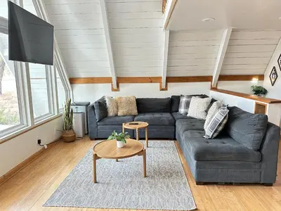 a living room with a couch and a table at Picturesque Yosemite A-Frame in Mariposa