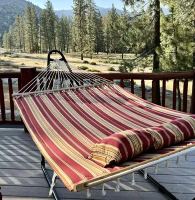 a hammock sitting on top of a deck at Peppermint Falls Ranch in Ponderosa