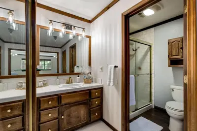 a bathroom with a sink and a toilet and a mirror at Large Seasonal Rental South Lake Tahoe in South Lake Tahoe